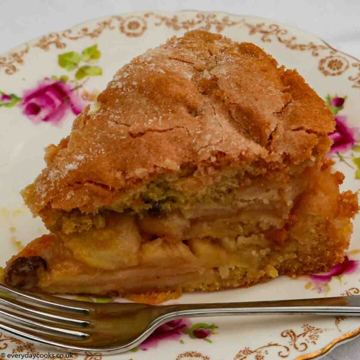 A slice of Apple Sponge Cake on a white plate