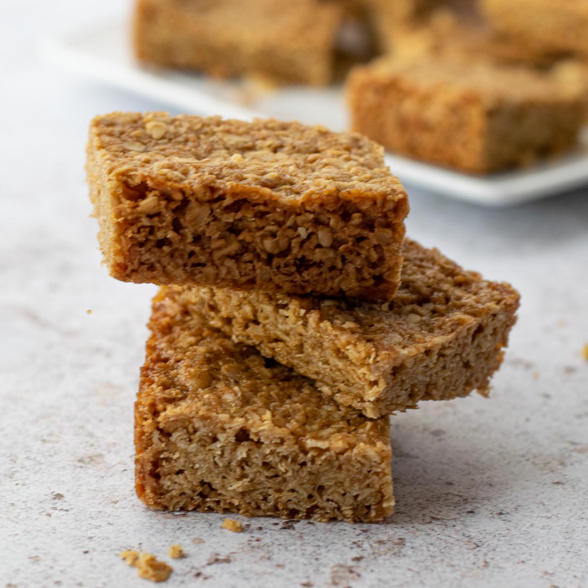 Stack of three Flapjacks with more in the background.