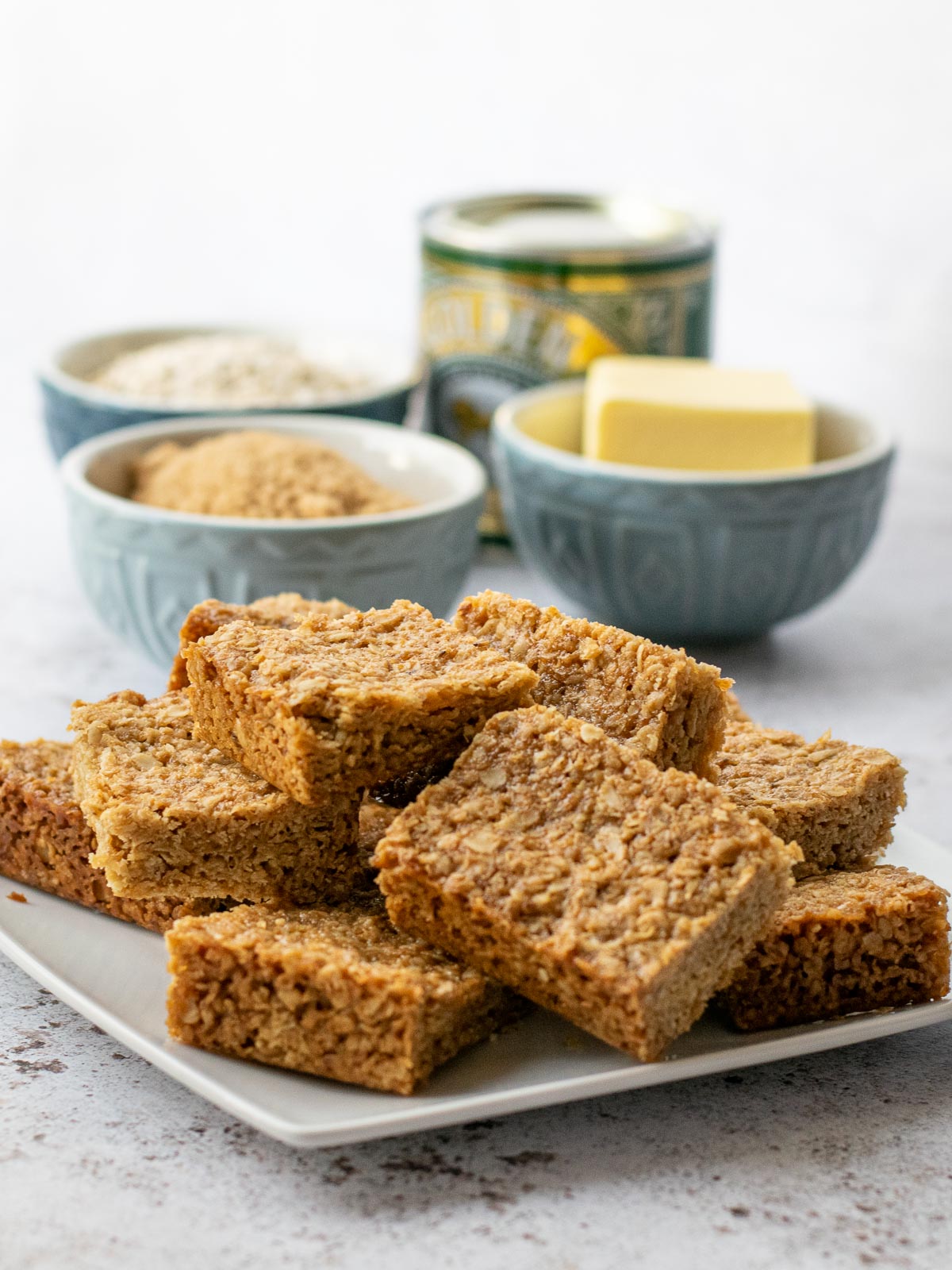 Plate of flapjack with ingredients in the background