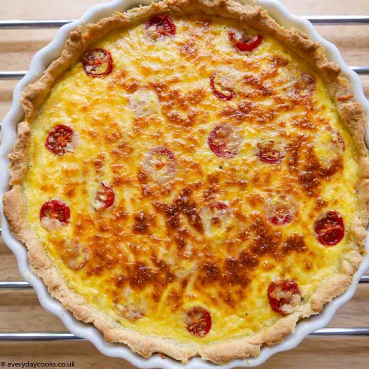 A whole Tuna and Tomato Quiche in a white china flan dish