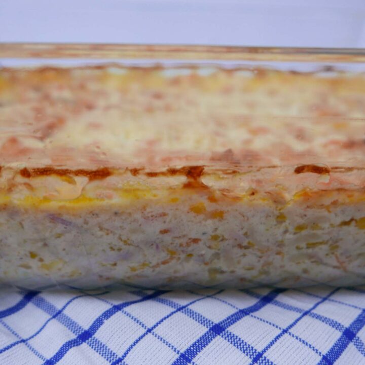 Tuna Pasta Bake in a rectangular glass casserole dish of tuna pasta bake with melted cheese on top.