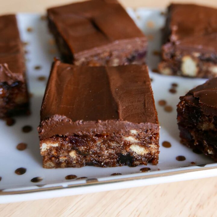 Christmas Chocolate Tiffin slices on a plate. Biscuit, chocolate and fruit soaked in liqueur as the base, coated with chocolate.