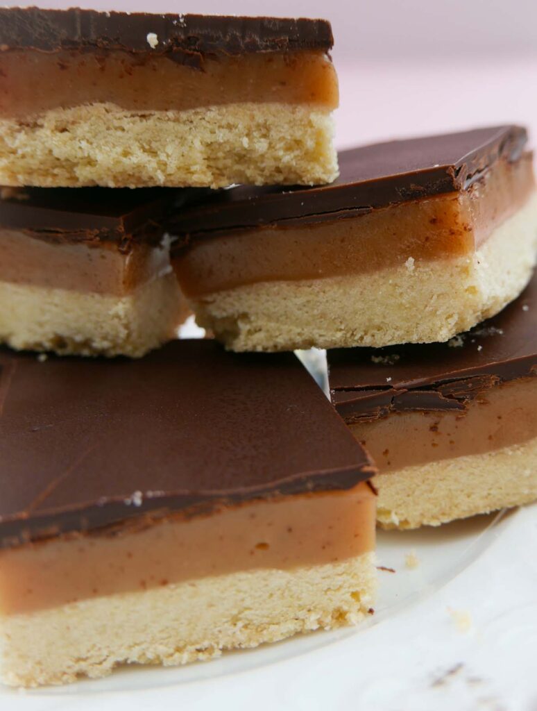 Five pieces of millionaires shortbread piled on top of each other.