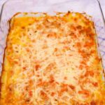 Tuna Pasta Bake in a rectangular glass casserole dish of tuna pasta bake with melted cheese on top.