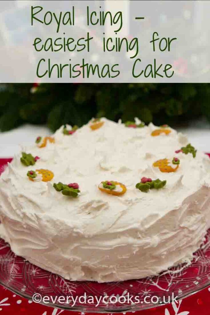 Christmas Cake with royal icing, decorated with sugarpaste holly and Christmas puddings