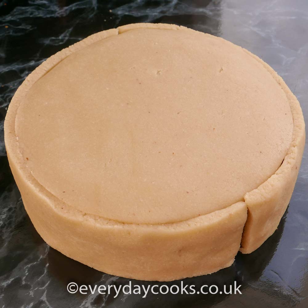 Marzipan covering a cake, waiting to be smoothed and finished