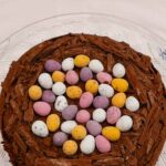 Chocolate Easter Nest Cake topped with chocolate cream and mini eggs