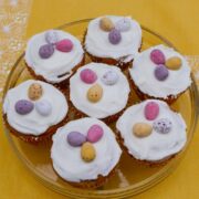 Simnel Cupcakes on a glass dish decorated with icing and chocolate eggs