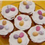Simnel cupcakes topped with icing and chocolate eggs