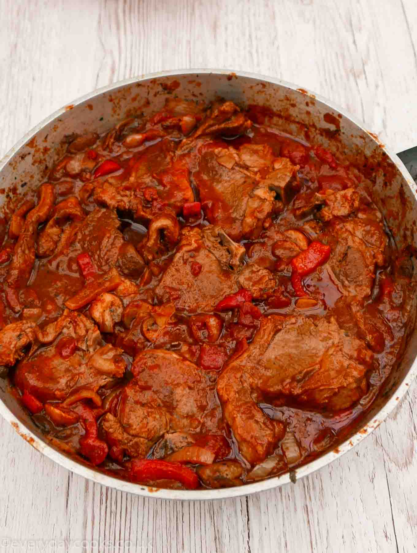 Lamb Chops in tomato sauce in a large pan