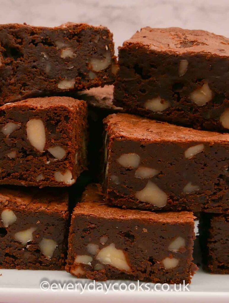 A stack of the ultimate chocolate brownies on a white plate