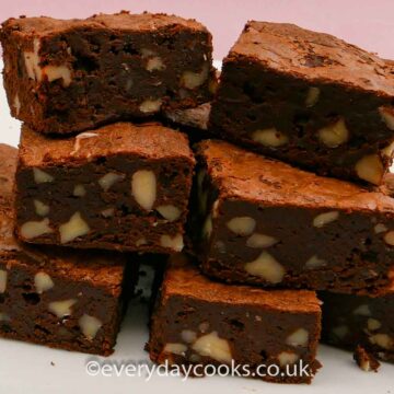 A stack of the ultimate chocolate brownies on a white plate