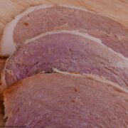 Slices of Slow Cooker Gammon on a board.