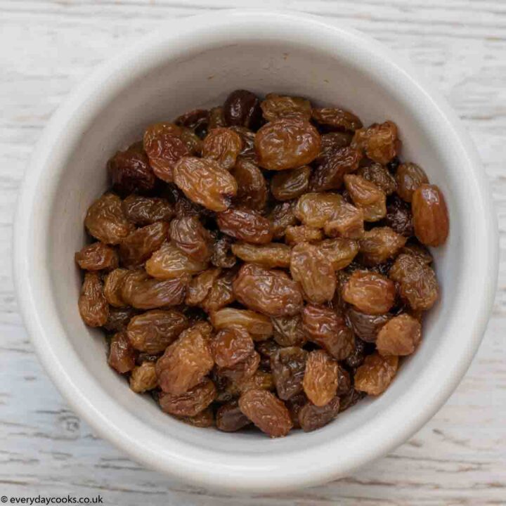 White bowl of soaked sultanas for Banana Loaf