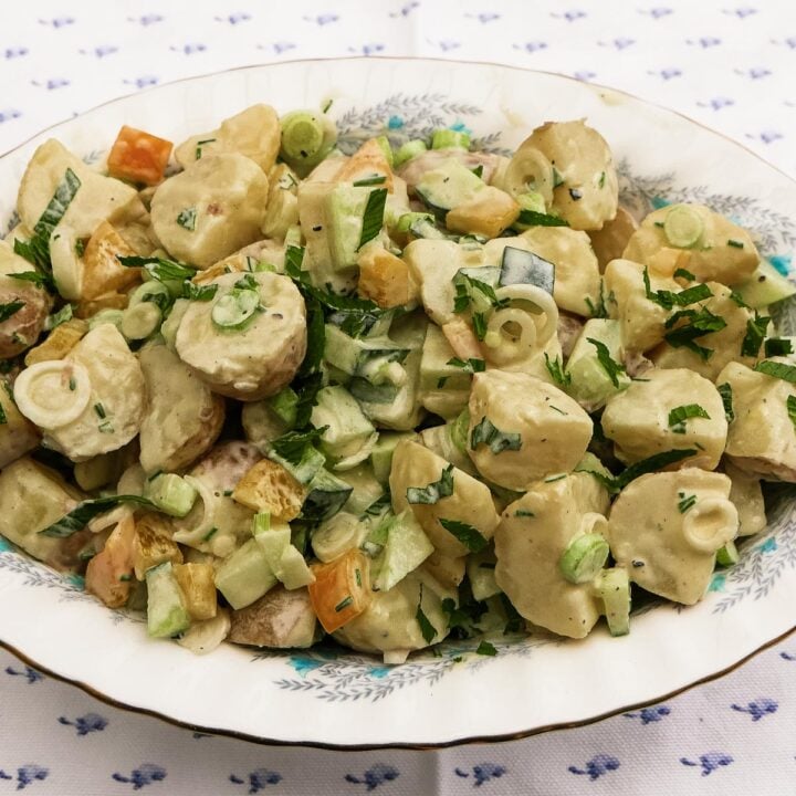 Potato Salad with diced cucumber and yellow pepper in an oval dish
