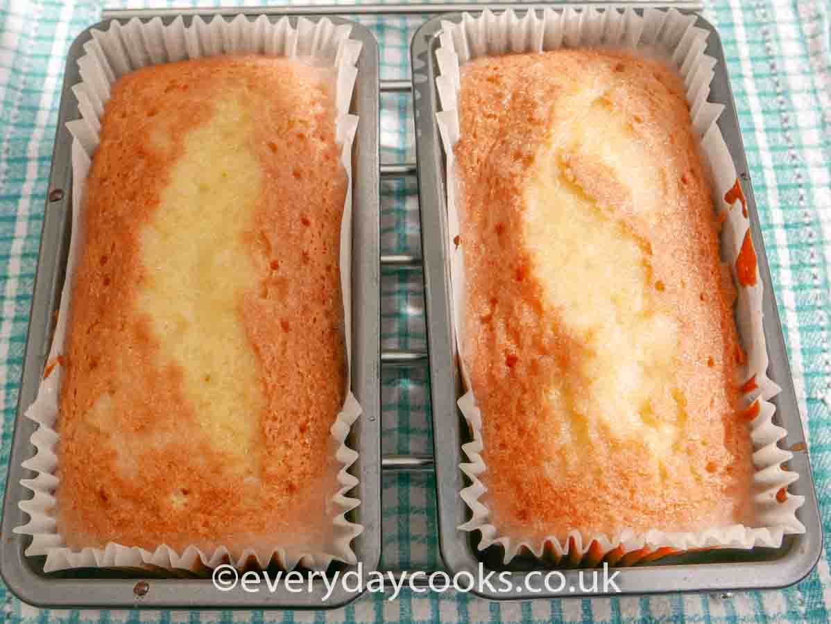 Two Crunchy Lemon Drizzle Loaves on a cooling rack