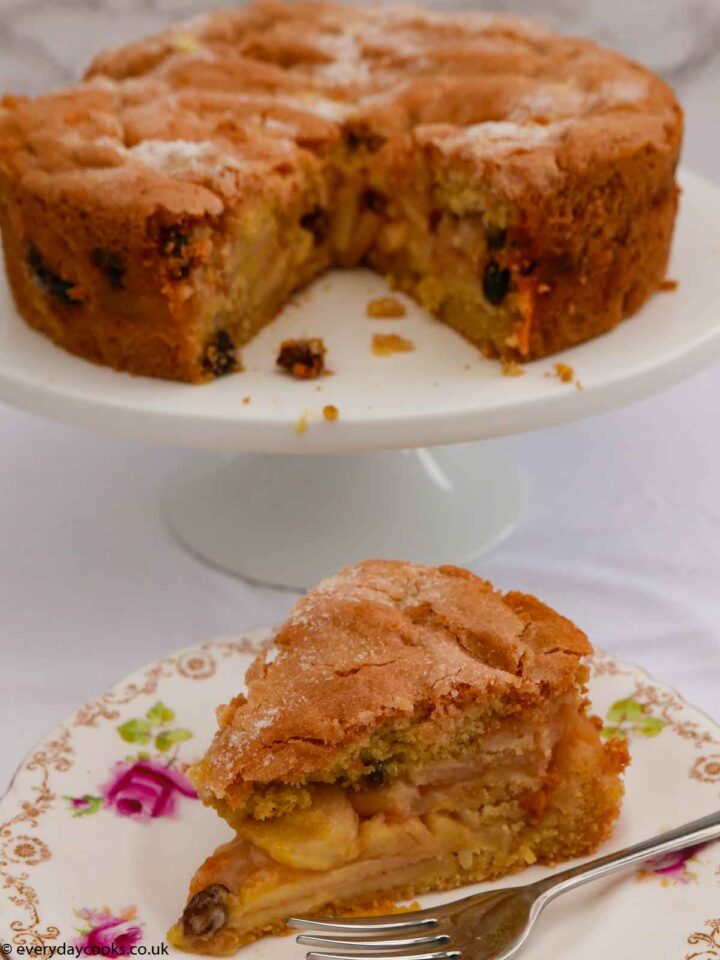 A slice of Apple Sponge Cake with the rest of the cake in the background
