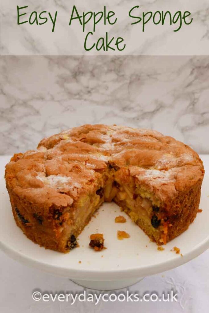 Apple Sponge Cake with a slice removed, on a white plate