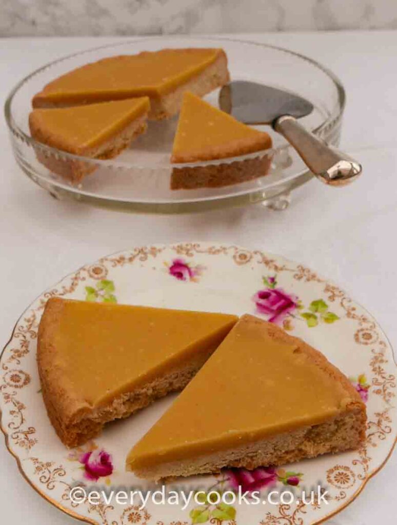 Slices of Ginger Shortbread with ginger fudge icing on a patterned plate.