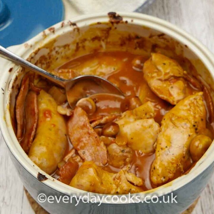 Chicken Chasseur in a blue casserole dish with a spoon