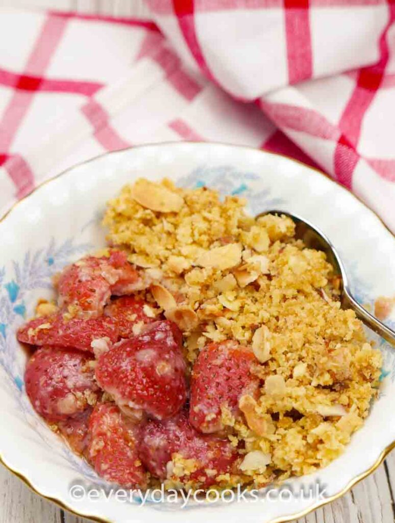 Strawberry Crumble with a spoon in a blue patterned bowl