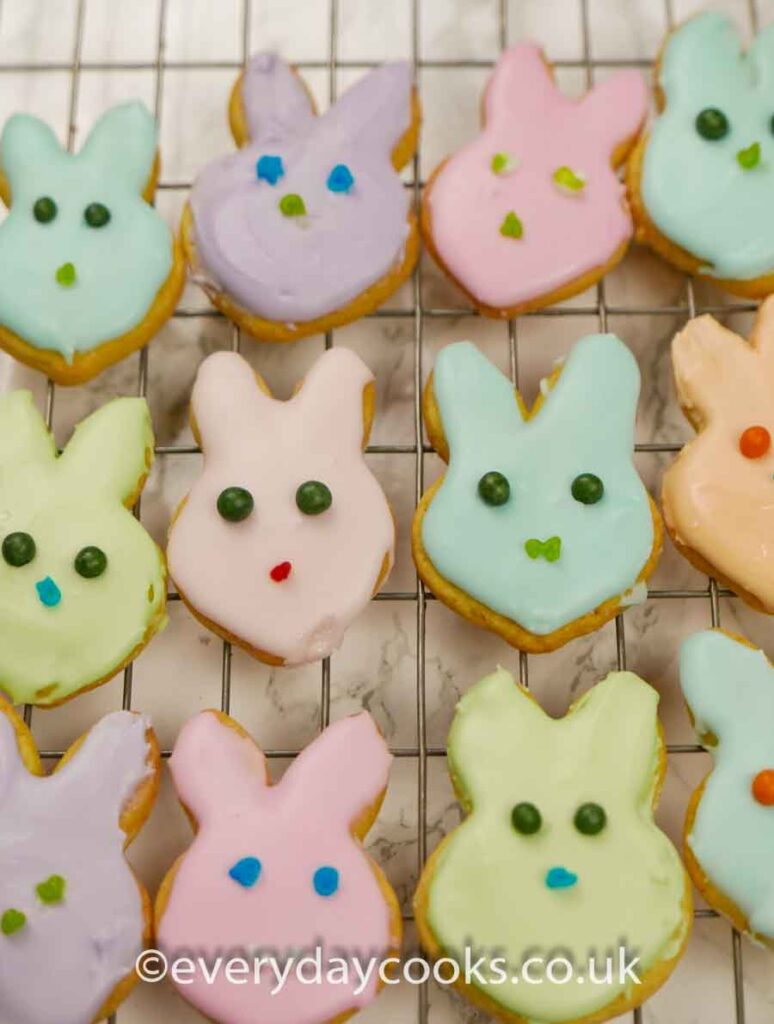 Iced Easter Bunny Biscuits and chicks in a variety of colours on a wire rack