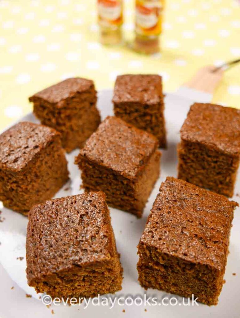 Squares of Gingerbread Traybake on a grey plate.