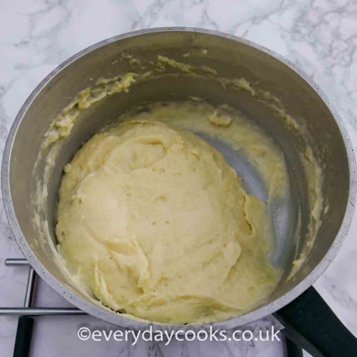 Flour and butter mixture with first addition of milk in a saucepan