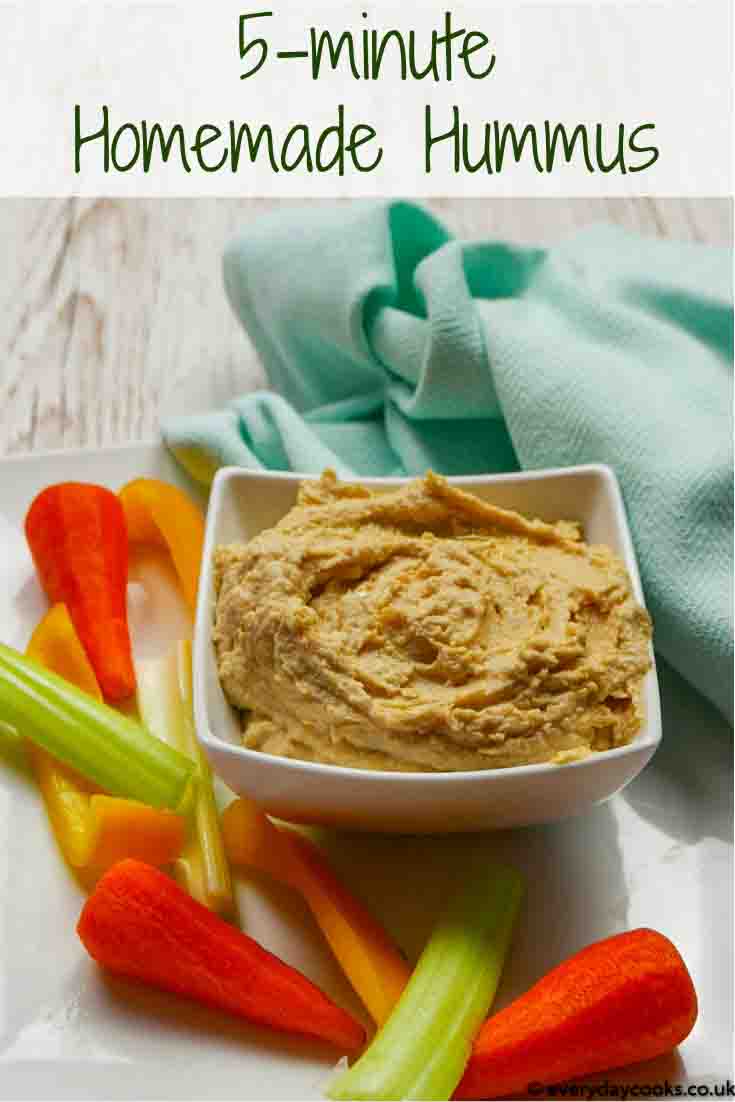 A white dish of Homemade Hummus with raw vegetables