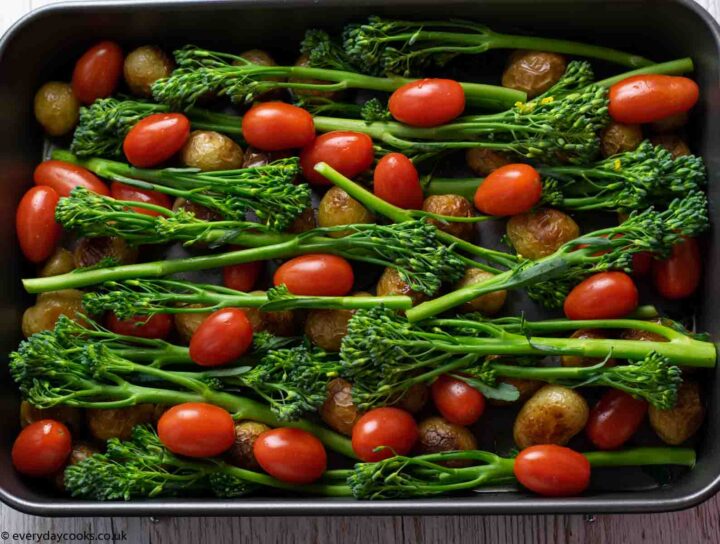 Green veg and tomatoes ready for roasting for Easy Cod Traybake