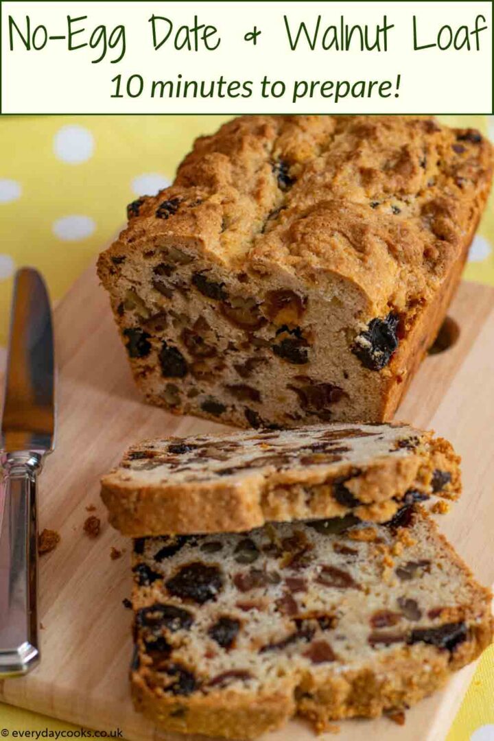 A cut Date and Walnut Loaf with 2 slices on a wooden board