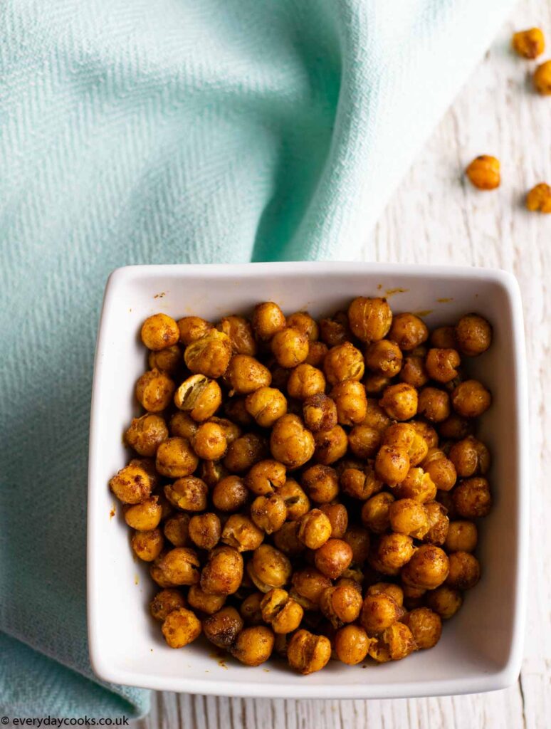 Spicy Roasted Chickpeas in a white bowl on a blue cloth