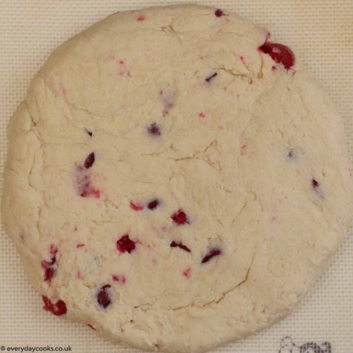 Rolled out disc of cherry scone dough