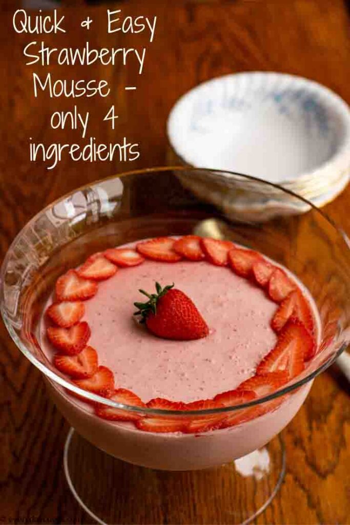 Easy Strawberry Mousse decorated with strawberry slices, in a glass bowl on a wooden table