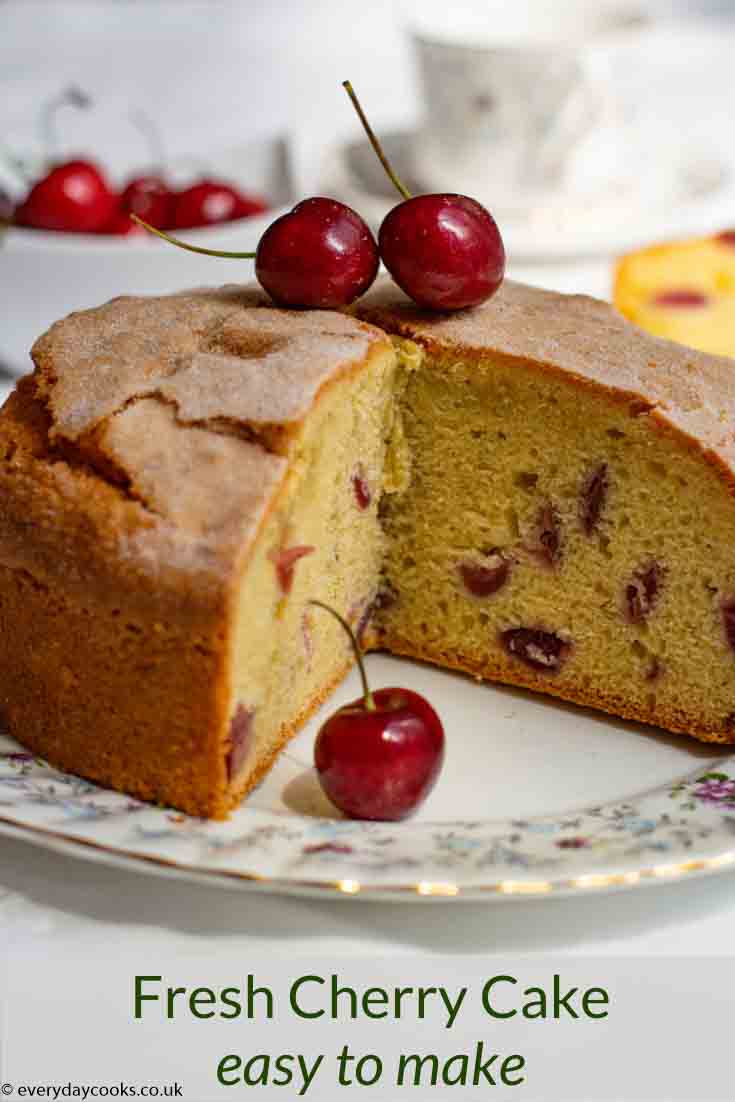 Fresh Cherry Cake, with a slice removed, on a patterned plate