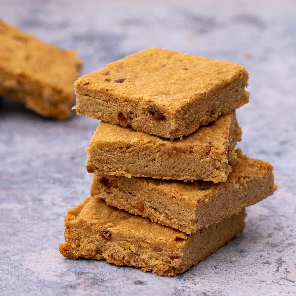 Stack of four Cherry Shortbread biscuits with one in the background