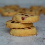 Stack of three Cherry Shortbread biscuits with more in the background