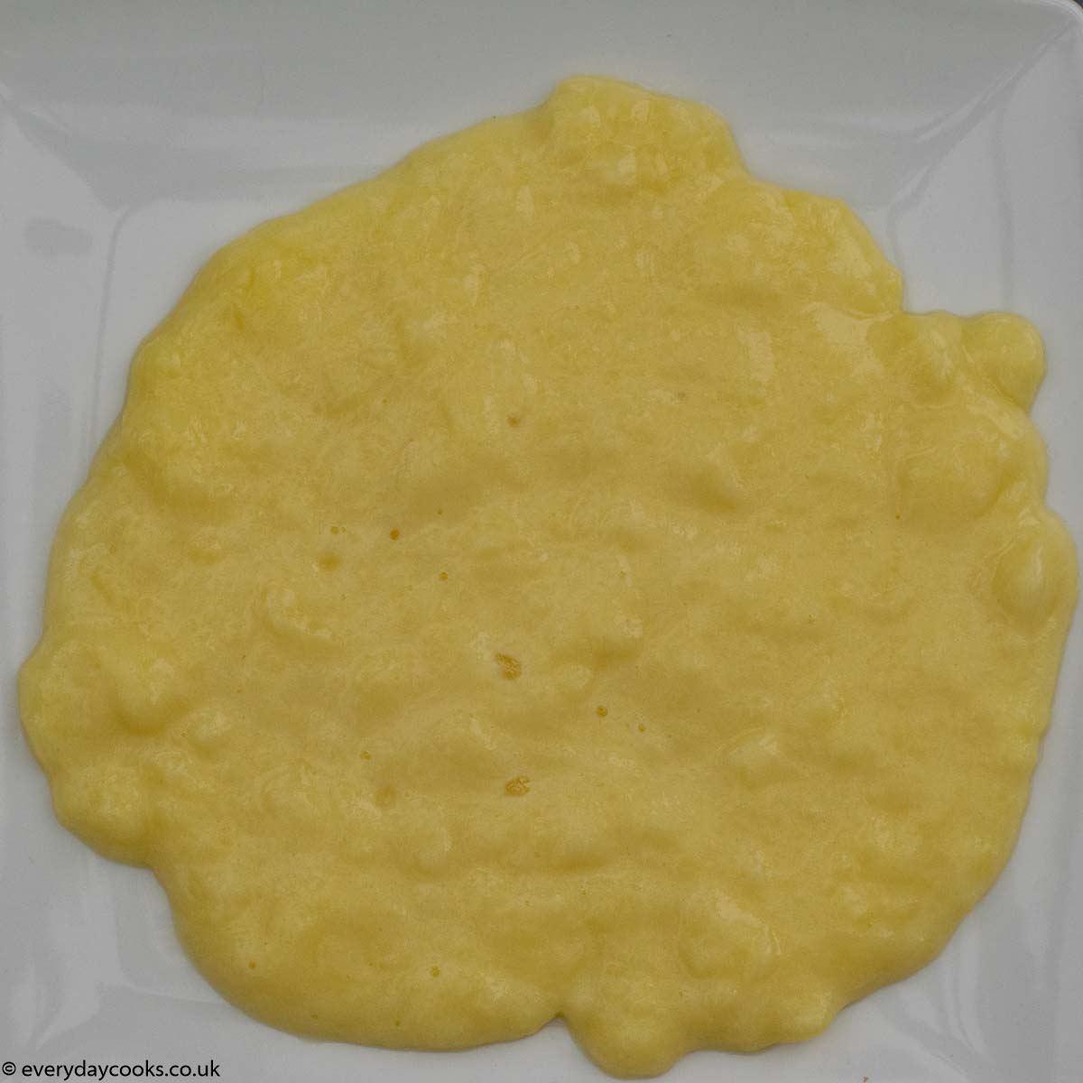 Lumpy custard on a white plate