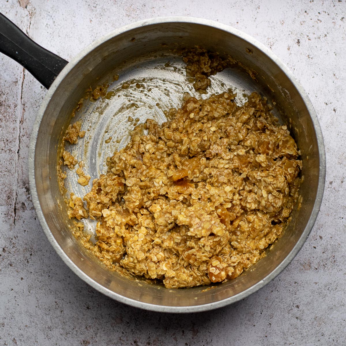 Mixed ingredients in the saucepan for Apricot Oat Bars