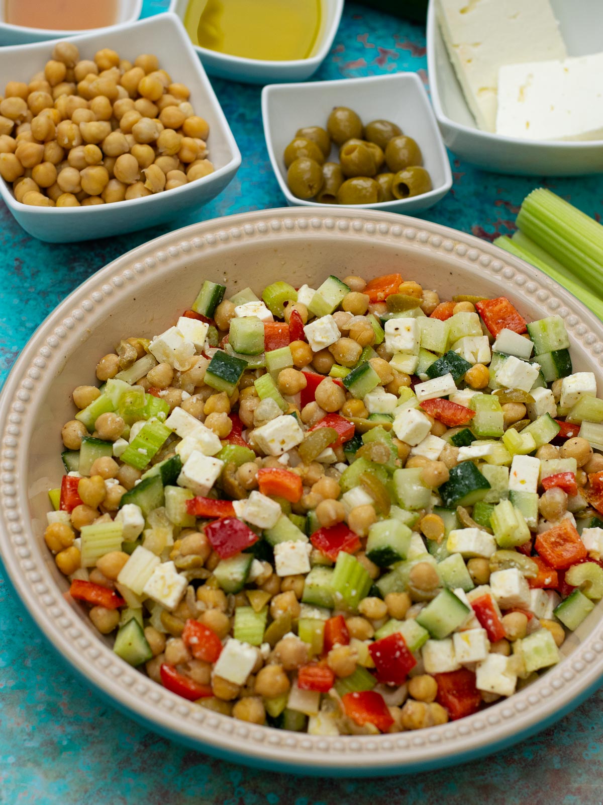 Feta Chickpea Salad with ingredients on a blue background