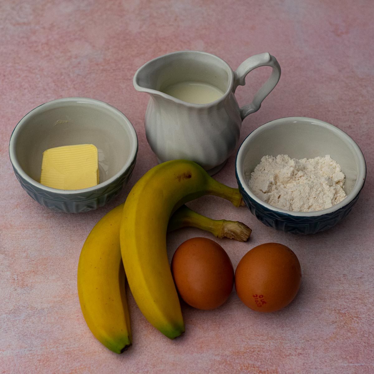 Ingredients for Banana Pancakes - 2 bananas, 2 eggs, milk in a jug, flour, butter